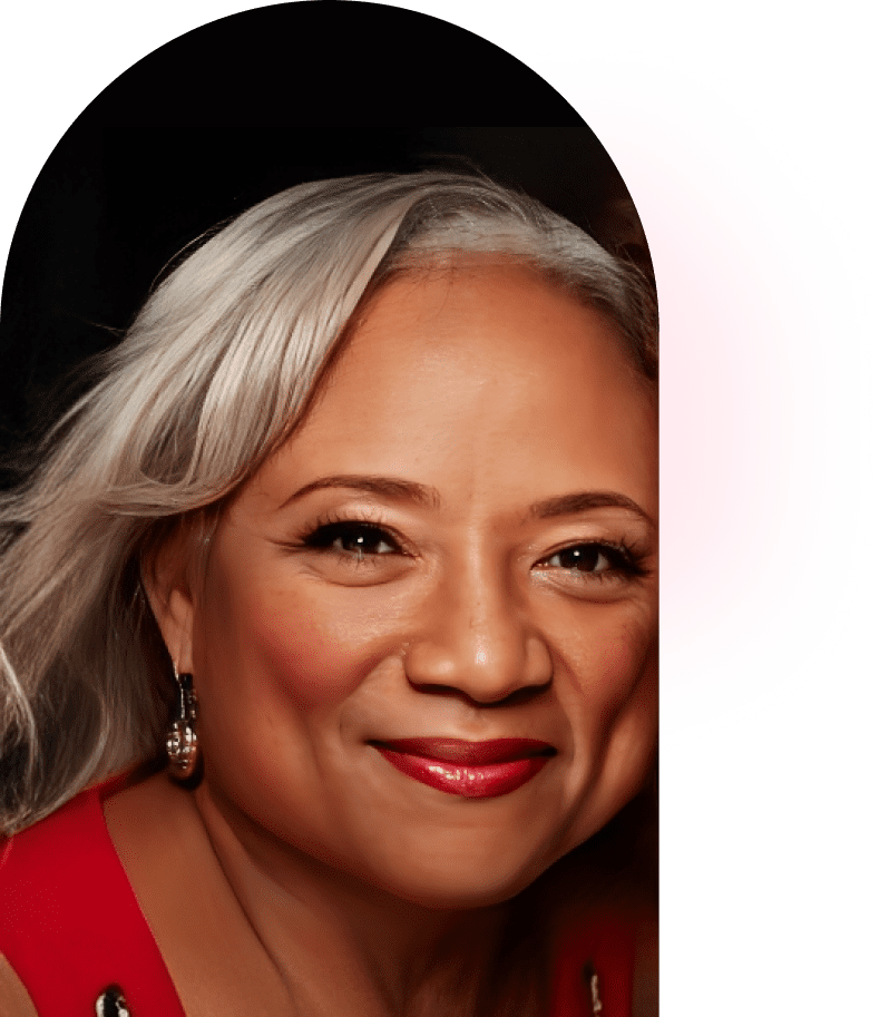 Portrait of a smiling woman with silver hair and red lipstick.